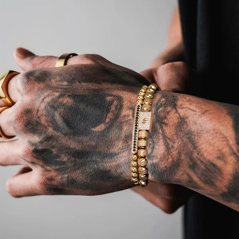 A guy wearing a 2-piece gold bracelet